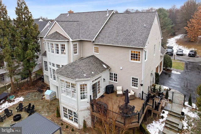 rear view of property featuring a wooden deck