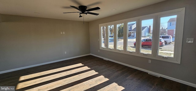 empty room with ceiling fan and dark hardwood / wood-style floors