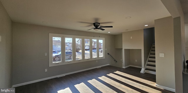 empty room featuring ceiling fan and dark hardwood / wood-style flooring