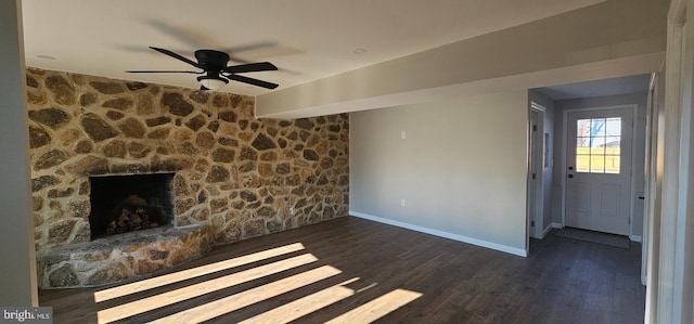 unfurnished living room with a fireplace, ceiling fan, and dark hardwood / wood-style flooring