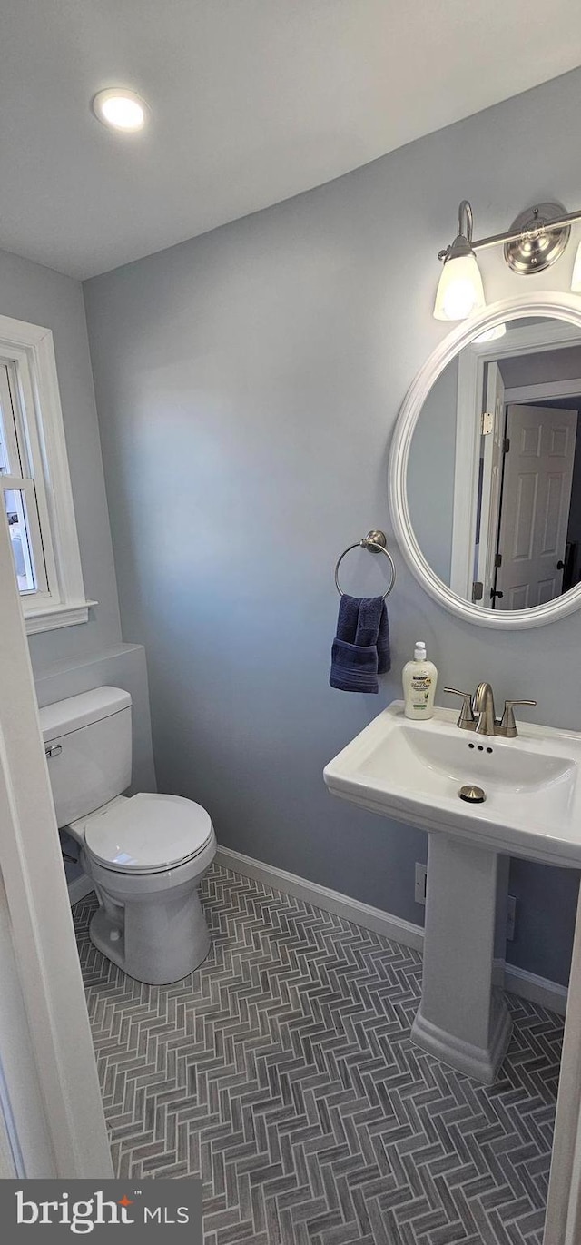 bathroom with tile patterned flooring and toilet