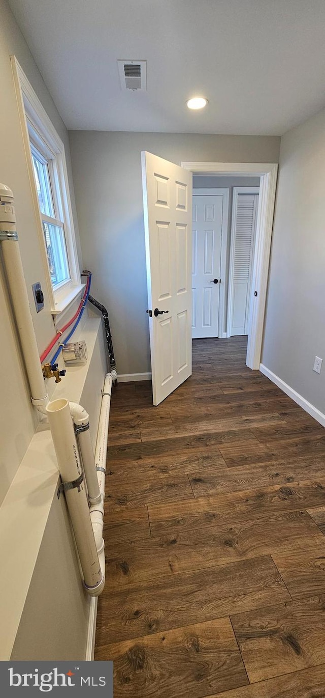 hall with dark hardwood / wood-style floors