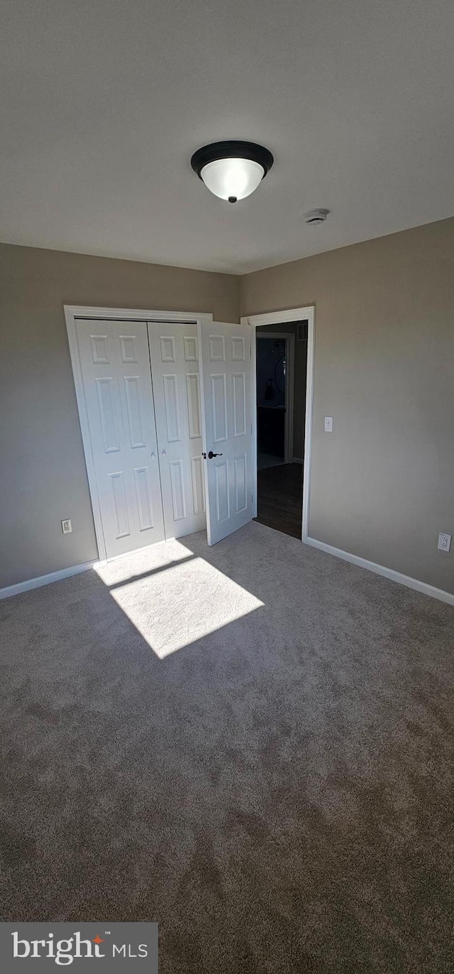 unfurnished bedroom featuring a closet and carpet