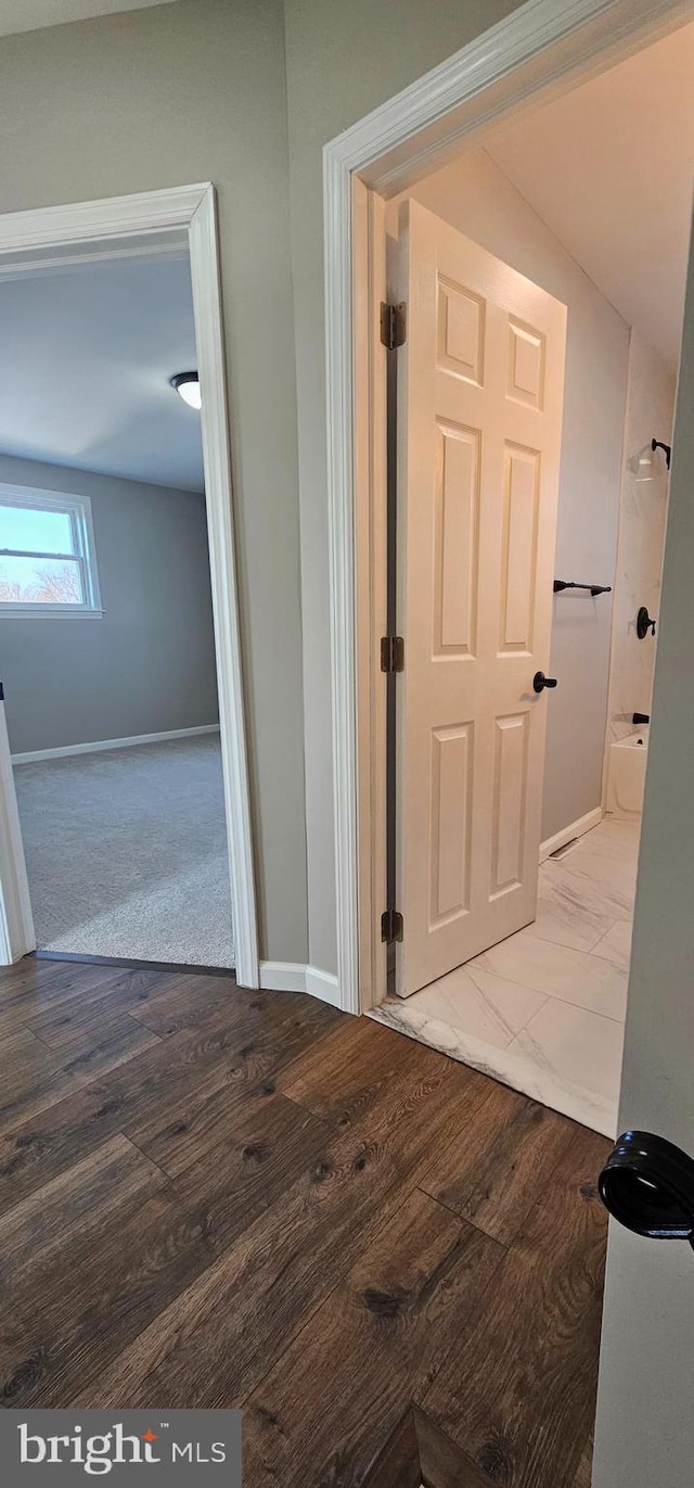 hallway featuring light carpet