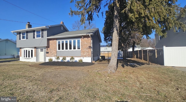 rear view of house featuring a yard