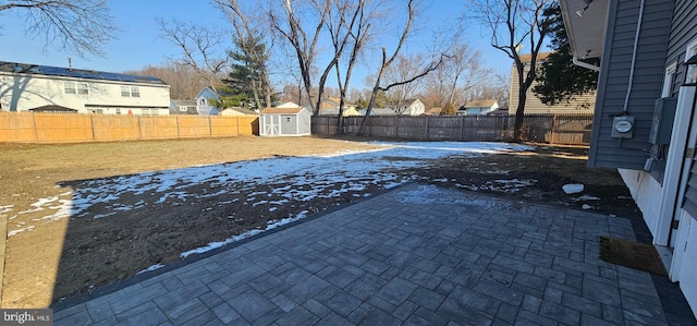 view of yard featuring a shed and a patio area