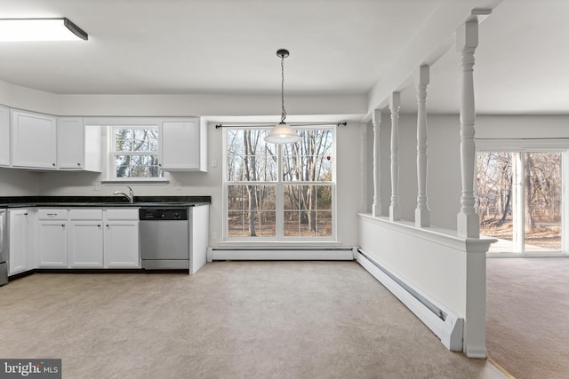 kitchen featuring baseboard heating, stainless steel dishwasher, light colored carpet, and pendant lighting