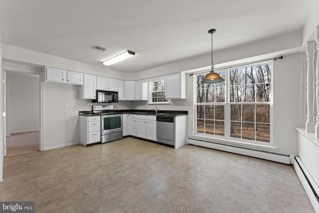 kitchen with decorative light fixtures, white cabinets, baseboard heating, and appliances with stainless steel finishes