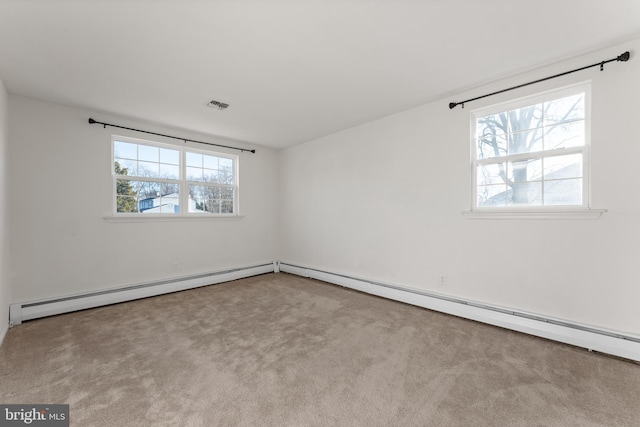 empty room featuring a wealth of natural light and light colored carpet