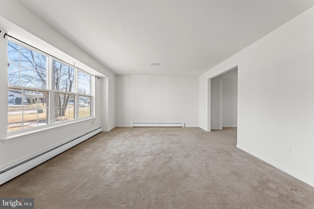 carpeted empty room featuring baseboard heating