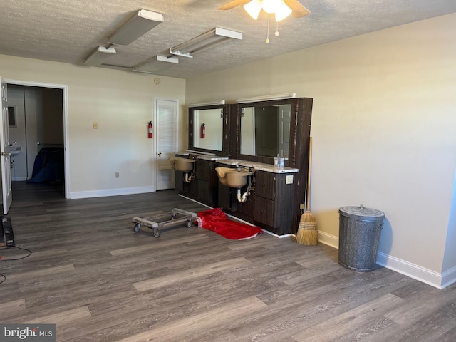 misc room with hardwood / wood-style floors, sink, and a textured ceiling