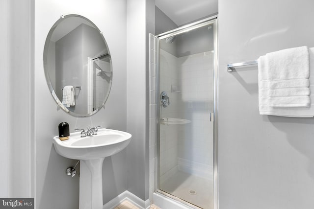 bathroom featuring a shower with door