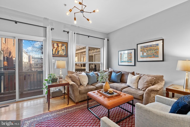 living room with hardwood / wood-style flooring and a chandelier