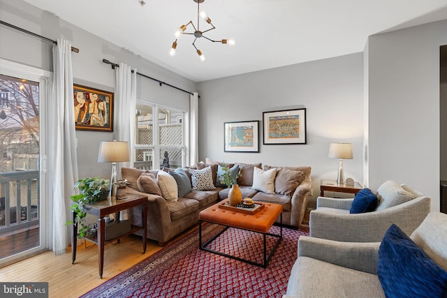 living room featuring hardwood / wood-style flooring and a chandelier