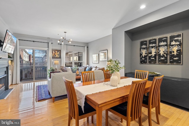 dining area featuring light hardwood / wood-style flooring and a chandelier