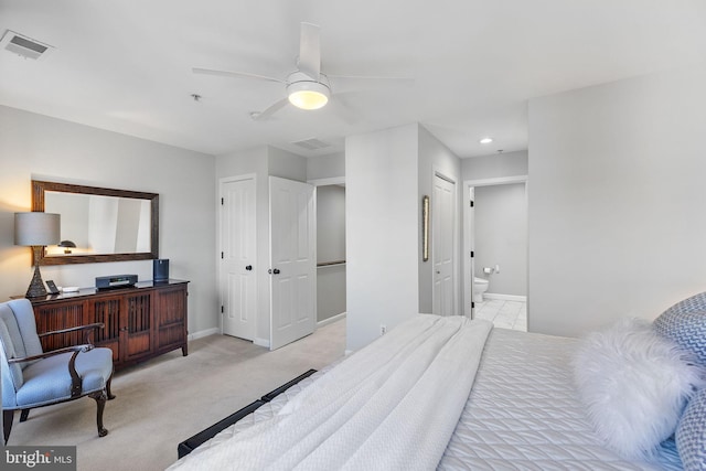 carpeted bedroom with ceiling fan and ensuite bath