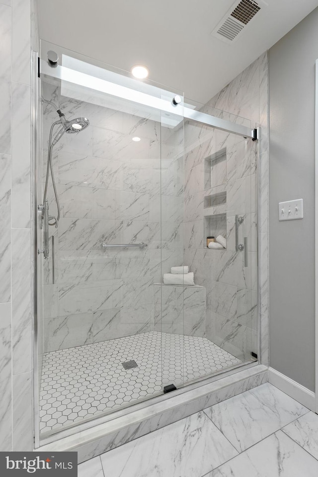 bathroom with a shower with shower door