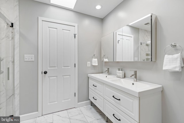 bathroom featuring vanity, a skylight, and walk in shower