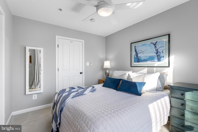 carpeted bedroom with ceiling fan and a closet