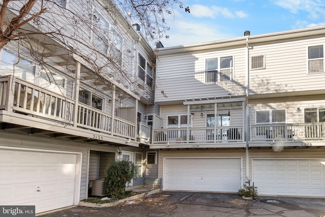 rear view of property with central AC