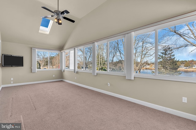 unfurnished sunroom featuring ceiling fan, plenty of natural light, a water view, and lofted ceiling with skylight