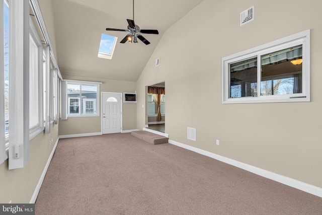 unfurnished sunroom featuring lofted ceiling with skylight and ceiling fan