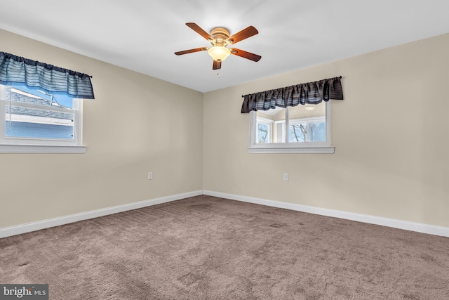 carpeted spare room with ceiling fan and a healthy amount of sunlight