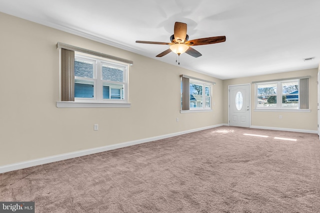 carpeted empty room featuring ceiling fan