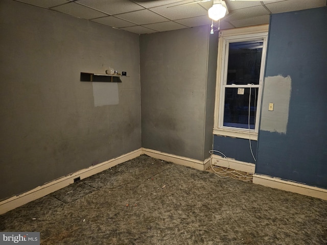 empty room with carpet floors and a paneled ceiling