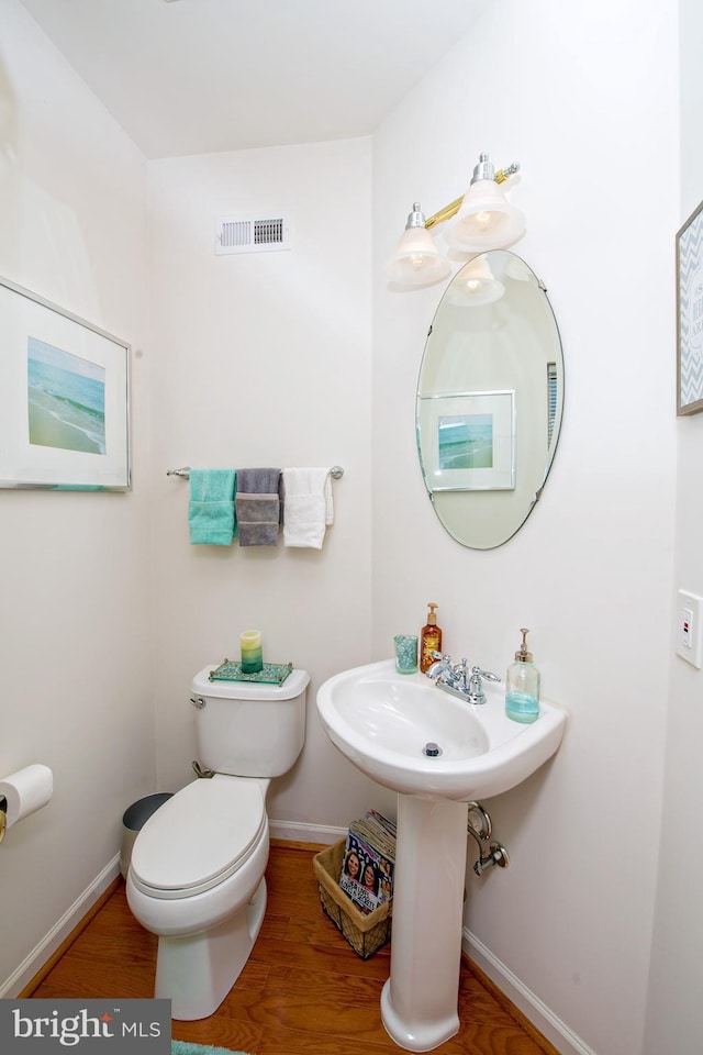 bathroom featuring toilet and hardwood / wood-style flooring