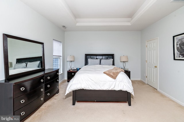 carpeted bedroom featuring a tray ceiling