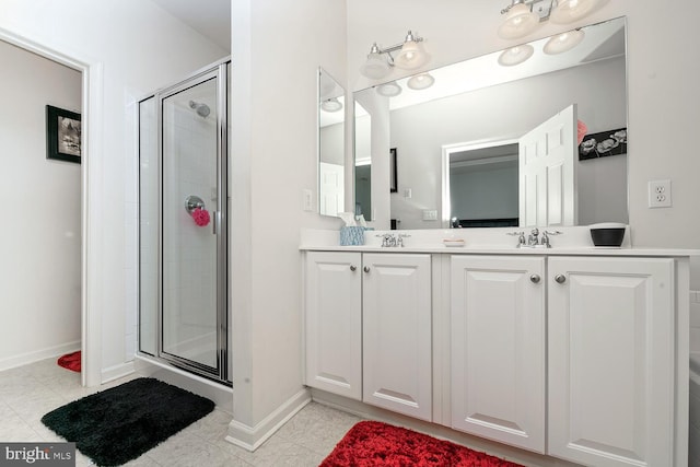 bathroom with tile patterned floors, vanity, and an enclosed shower