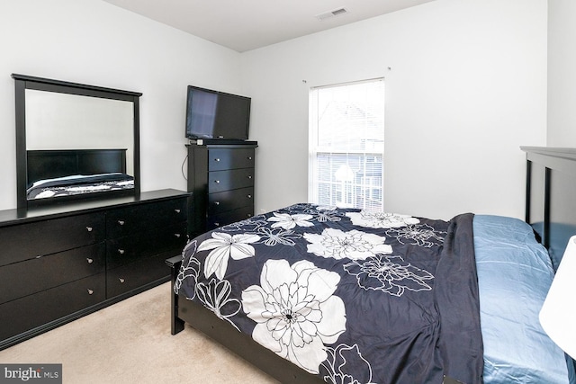 bedroom featuring light carpet