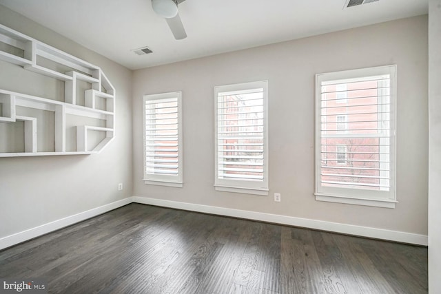 unfurnished room featuring ceiling fan and dark wood-type flooring