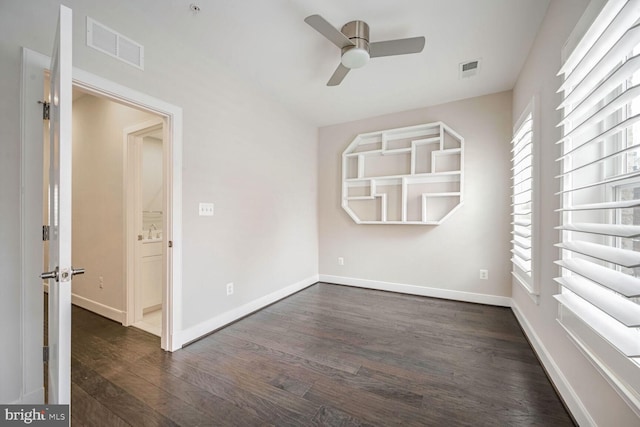 unfurnished room featuring ceiling fan and dark hardwood / wood-style floors