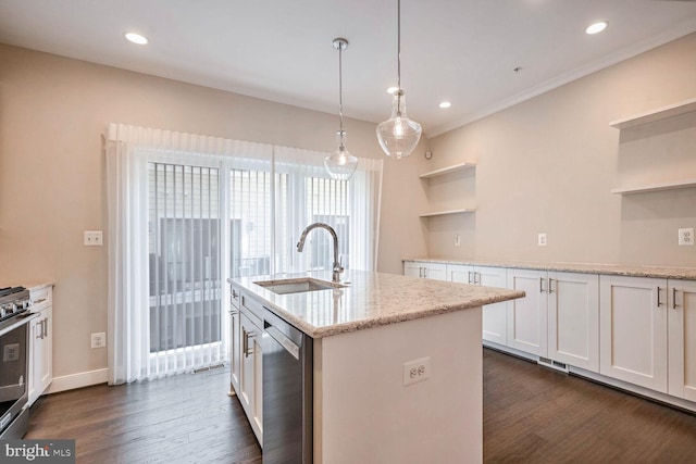 kitchen featuring pendant lighting, sink, light stone countertops, appliances with stainless steel finishes, and white cabinetry