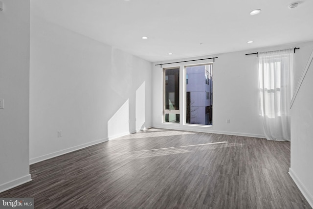 empty room with dark wood-type flooring