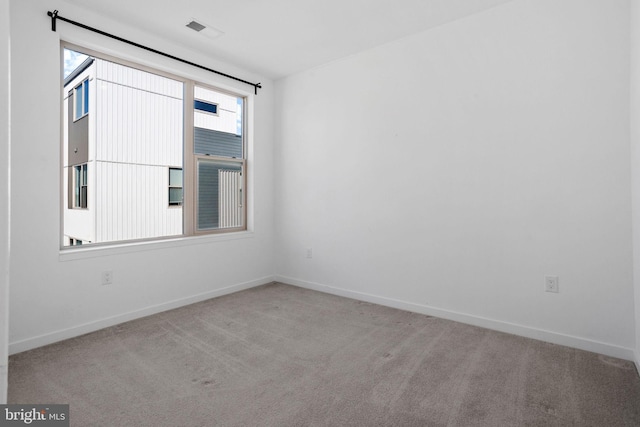 unfurnished room with light carpet