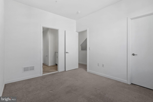 unfurnished bedroom featuring light colored carpet