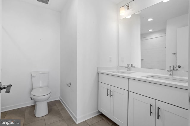 bathroom featuring tile patterned flooring, vanity, and toilet