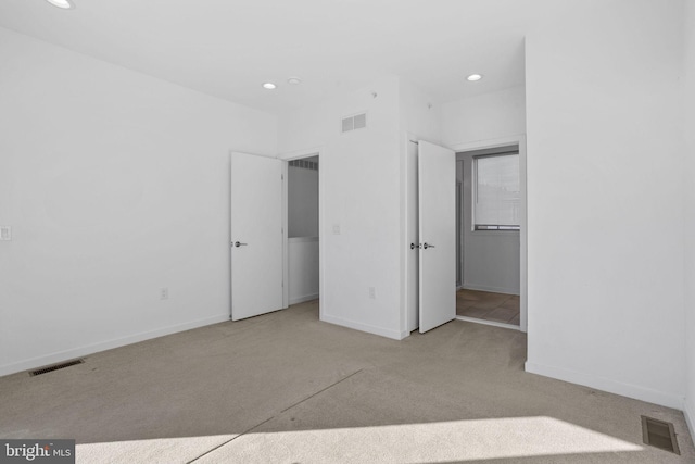 unfurnished bedroom with light carpet