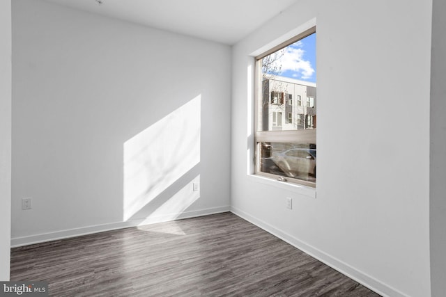 empty room with dark hardwood / wood-style flooring