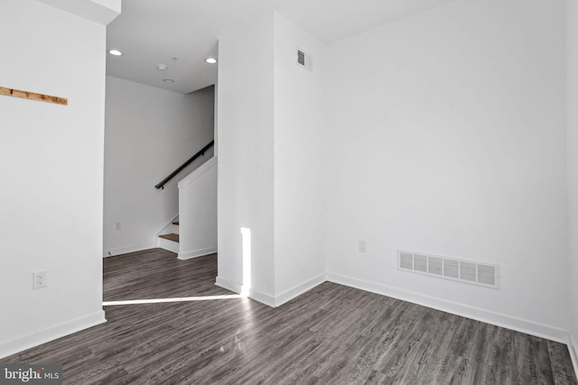 empty room featuring dark hardwood / wood-style flooring