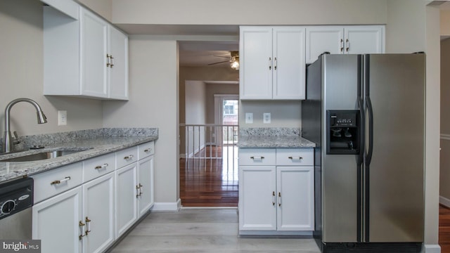 kitchen featuring a sink, appliances with stainless steel finishes, and white cabinetry