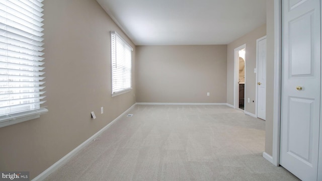 unfurnished bedroom with light carpet and baseboards