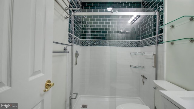 full bath featuring vanity, toilet, and a stall shower