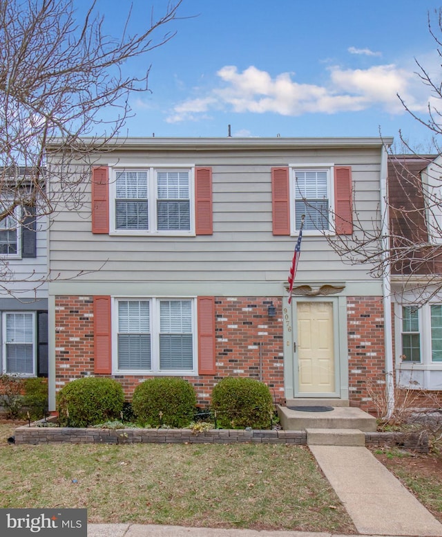 townhome / multi-family property with brick siding