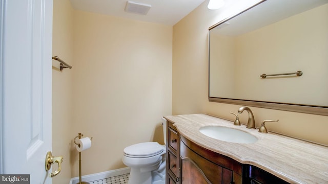 half bath featuring visible vents, baseboards, toilet, and vanity