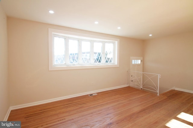 spare room with light hardwood / wood-style flooring