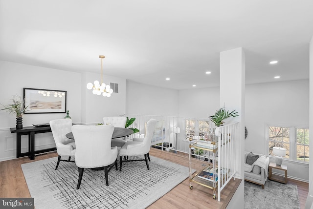 dining room featuring an inviting chandelier and light wood-type flooring